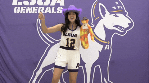 Woman in Purple Hat and LSU Jersey in Front of Purple Banner