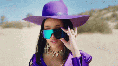 Woman in Purple Hat and Sunglasses Covering Eyes