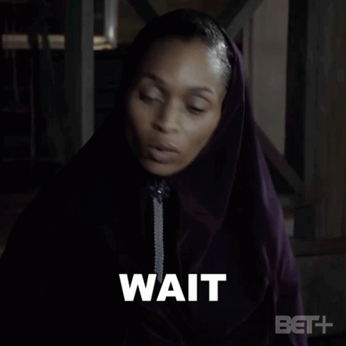 Woman in Purple Hooded Cape Saying Just Wait