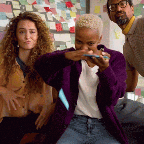 Woman In Purple Jacket Holding Sticky Note GIF