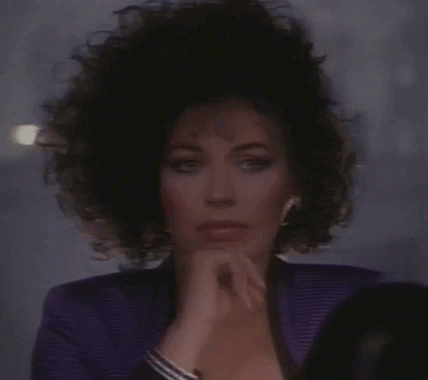 Woman in Purple Jacket Looking in Mirror