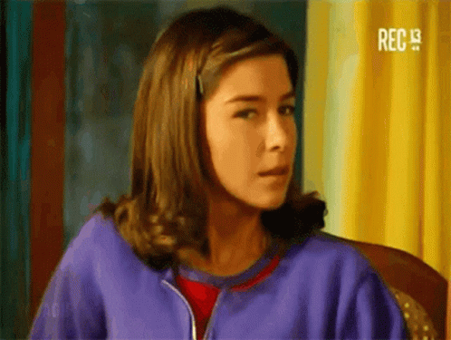 Woman in Purple Jacket Sitting Looking at Camera
