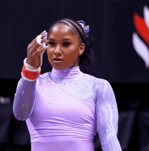 Woman in Purple Leotard Wiping Face