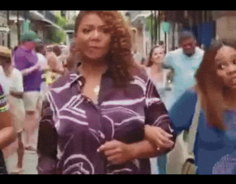 Woman In Purple Shirt In Crowd GIF