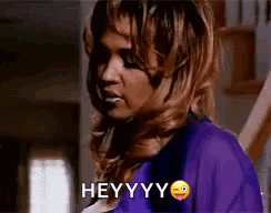 Woman in Purple Shirt Making Funny Face Saying Hey