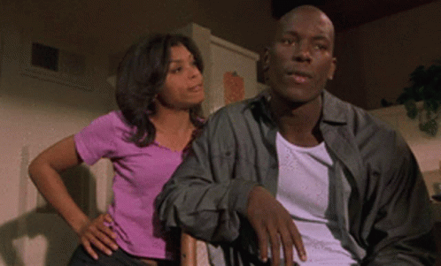 Woman in Purple Shirt Next to Man in White