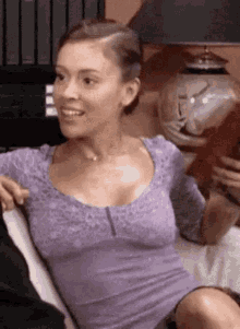 Woman in Purple Shirt Sitting With Man on Couch