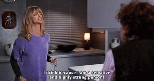 Woman in Purple Shirt Talking to Another Woman Holding Wine