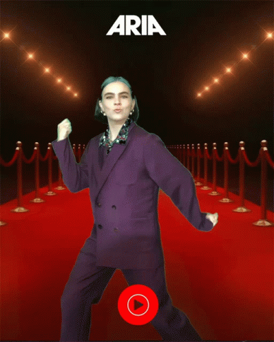Woman In Purple Suit Dancing On Red Carpet With Aria GIF