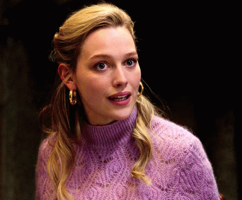 Woman In Purple Sweater And Gold Hoop Earrings GIF