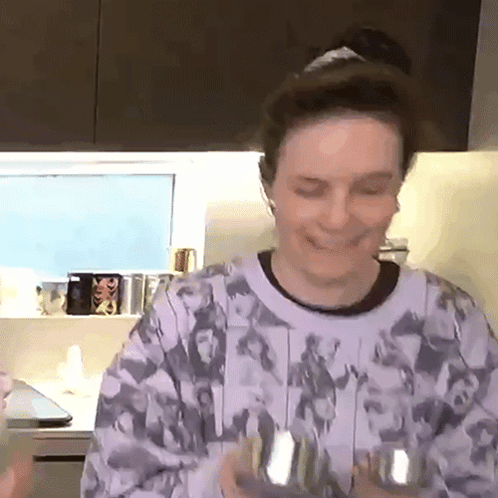 Woman in Purple Sweater Holding Dumbbells in Kitchen
