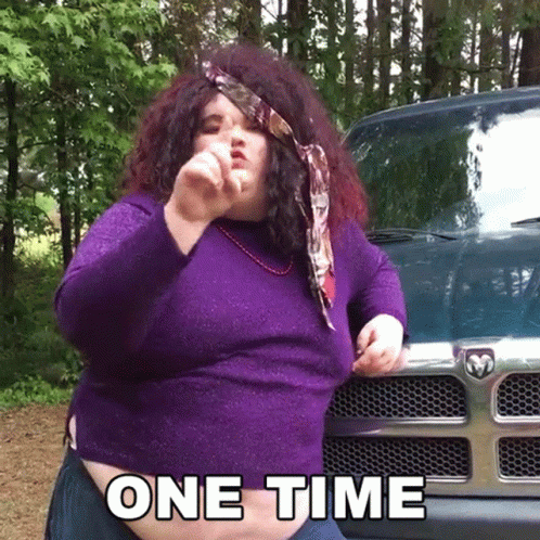 Woman in Purple Sweater in Front of Dodge Truck Saying One Time