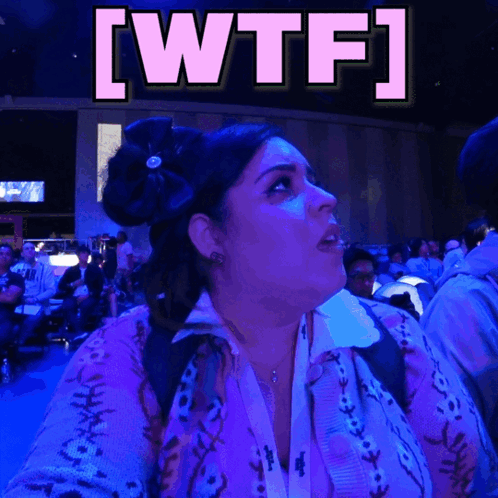 Woman in Purple Sweater Looking Up at WTF