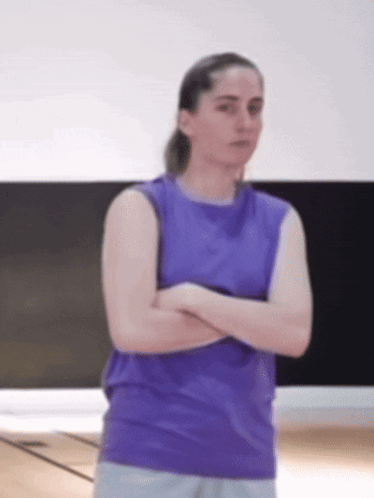 Woman in Purple Tank Top Arms Crossed in Gym