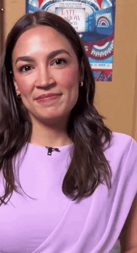 Woman In Purple Top Smiling In Front Of Late Show Poster GIF