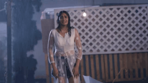 Woman in Rain With Umbrella and Neha Sign
