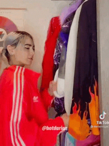Woman in Red Adidas Jacket by Closet