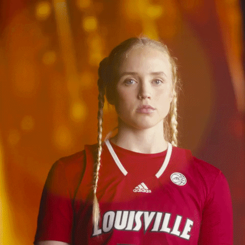 Woman in Red Adidas Louisville Jersey With Braids