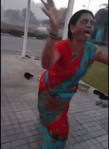 Woman in Red and Blue Dress Dancing