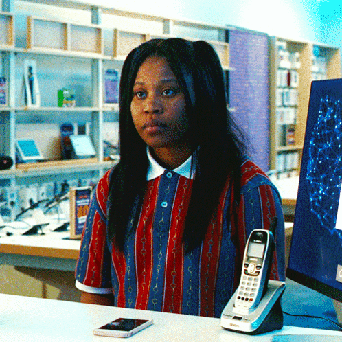 Woman In Red And Blue Striped Shirt At Desk With Siemens Phone GIF