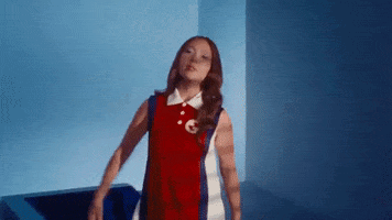 Woman in Red and White Dress Arms Outstretched
