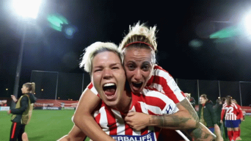 Woman In Red And White Herbalife Jersey Holding Another On Shoulders GIF