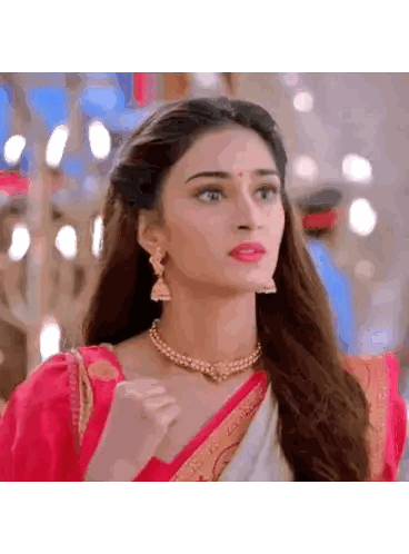Woman in Red and White Saree with Pearl Necklace and Earrings