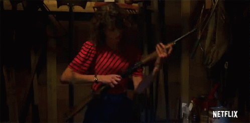 Woman In Red And White Striped Shirt Holding Shotgun GIF