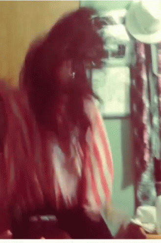 Woman In Red And White Striped Shirt Sitting In Front Of Refrigerator GIF