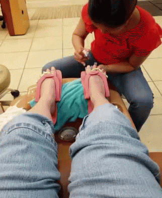 Woman in Red Applying Nail Polish