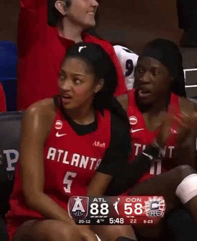Woman in Red Atlanta Jersey Sitting on Bench