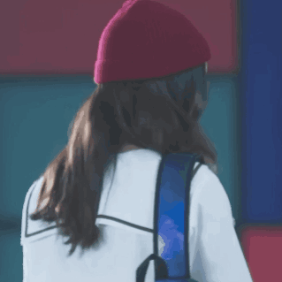 Woman in Red Beanie and Blue Backpack