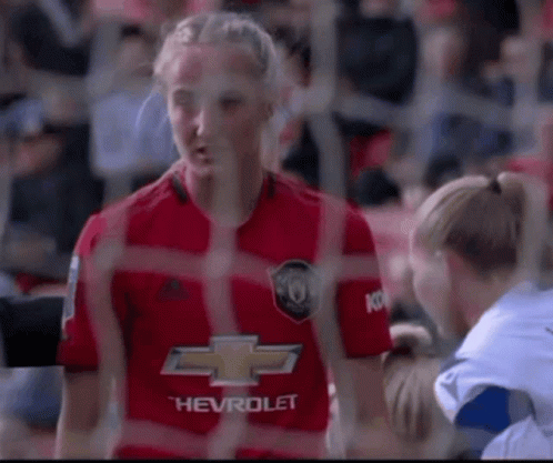 Woman in Red Chevrolet Jersey Talking to Woman in White