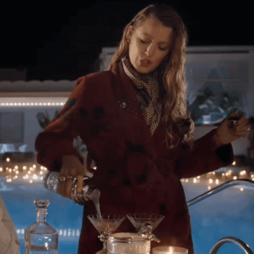 Woman in Red Coat Pouring Martini