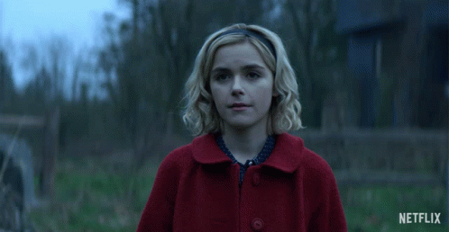 Woman in Red Coat Smiling With Netflix Logo