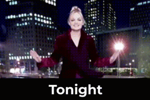 Woman in Red Coat Standing Before Tonight Sign