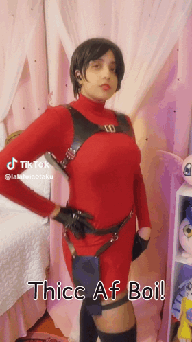 Woman in Red Costume in Front of Pink Curtain Thice Af Boi