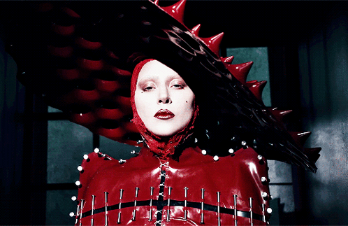 Woman in Red Costume With Spikes and Nails