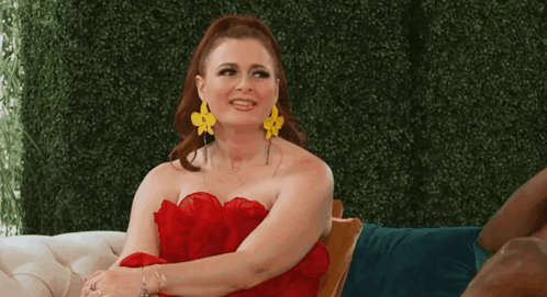 Woman In Red Dress And Yellow Earrings On Chair GIF