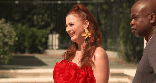 Woman in Red Dress and Yellow Earrings with Man