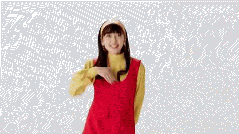 Woman in Red Dress and Yellow Sweater Giving Thumbs Up