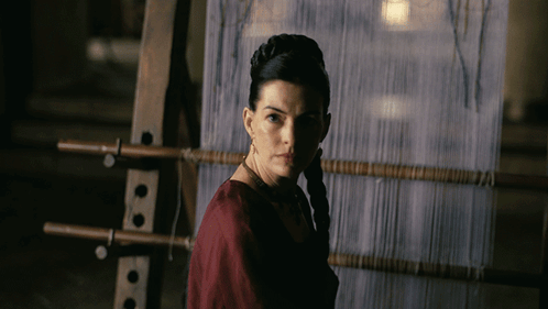 Woman in Red Dress at Loom in Dark