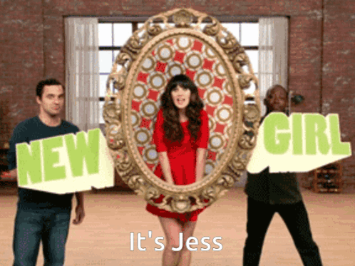 Woman in Red Dress Between Two Men Holding Signs New Girl and It's Jess