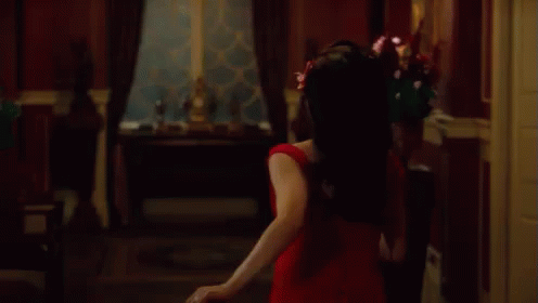 Woman in Red Dress Dancing With Falling Petals