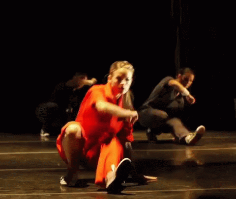 Woman in Red Dress Dancing With Man in Black Shirt