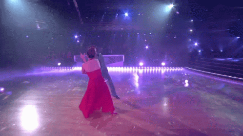 Woman in Red Dress Dancing With Man in Blue Suit