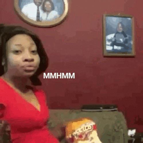 Woman in Red Dress Eating Chips on Couch