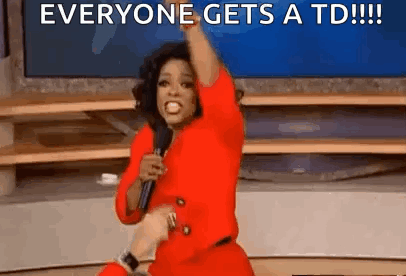 Woman in Red Dress Holding Microphone Saying Everyone Gets a TD