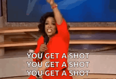 Woman in Red Dress Holding Microphone Saying You Get a Shot