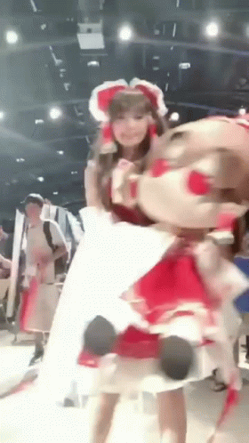 Woman in Red Dress Holding Stuffed Animal
